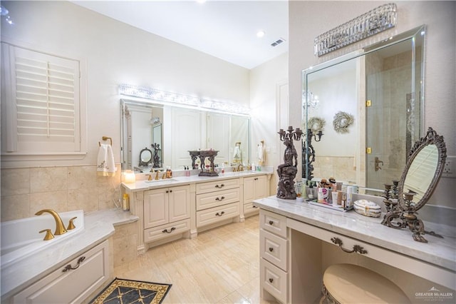 bathroom featuring a stall shower, vanity, visible vents, and a bath