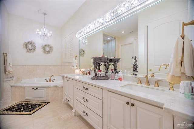 full bath with a garden tub, a chandelier, double vanity, and a sink