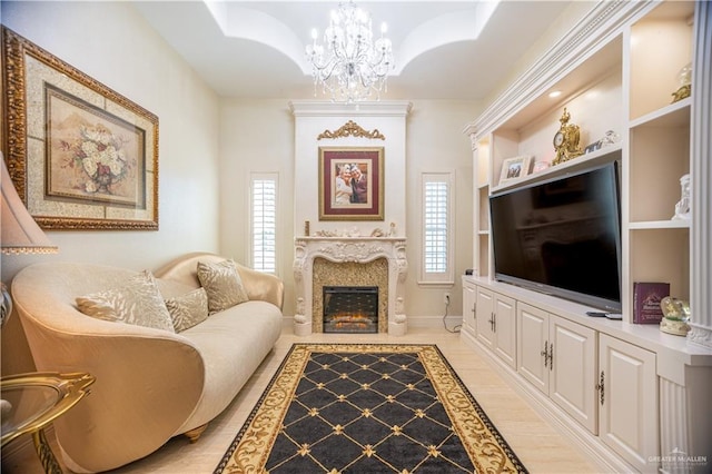living area with a fireplace and a notable chandelier