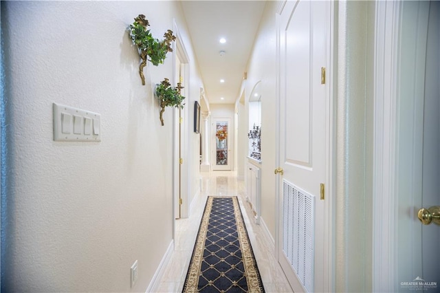 hall featuring visible vents and recessed lighting