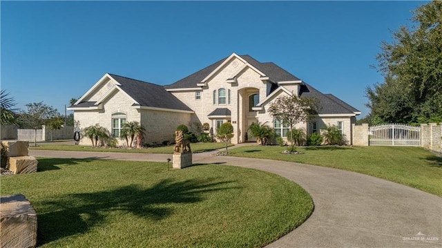 view of front facade featuring a gate, fence, a front lawn, and stone siding