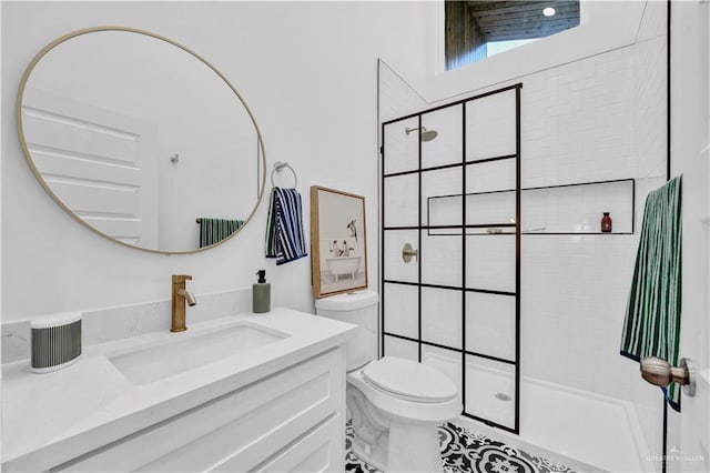 bathroom with vanity, a walk in shower, and toilet