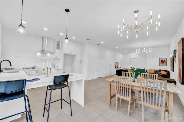dining area with recessed lighting and an inviting chandelier