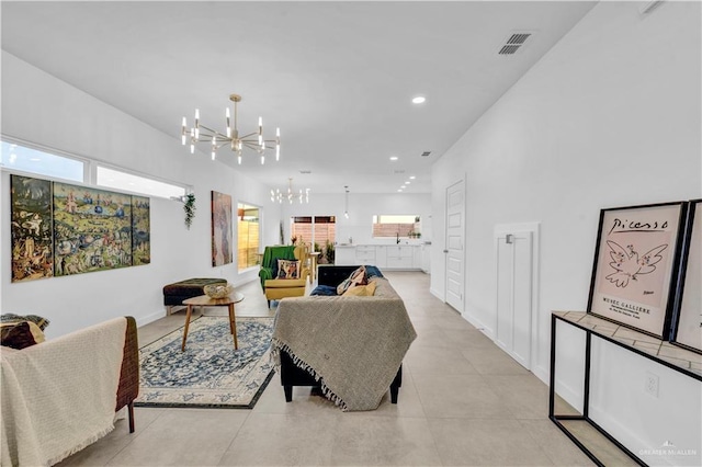 living area featuring recessed lighting, a chandelier, plenty of natural light, and visible vents