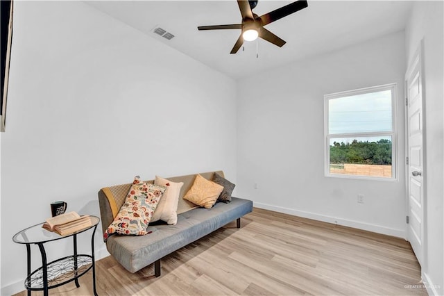 sitting room featuring visible vents, baseboards, ceiling fan, and wood finished floors