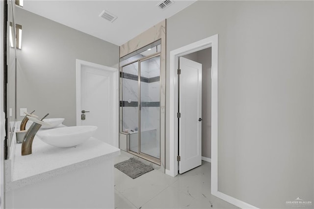 2000 Providence Ave, Mcallen, TX 78504 - bathroom featuring marble finish flooring, a marble finish shower, double vanity, and baseboards