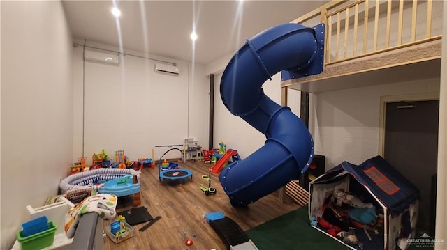 interior space featuring hardwood / wood-style floors and an AC wall unit