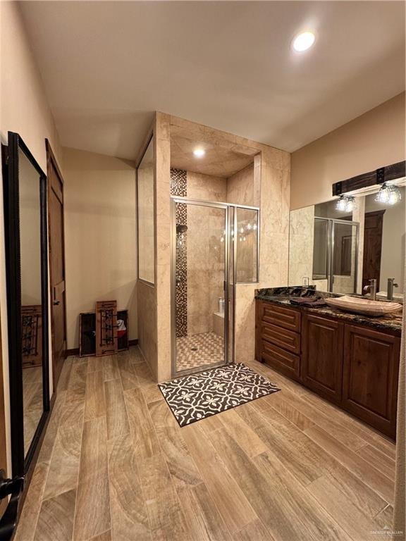 bathroom with vanity and a shower with door