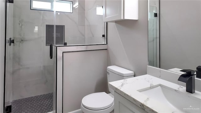 bathroom with vanity, toilet, and walk in shower