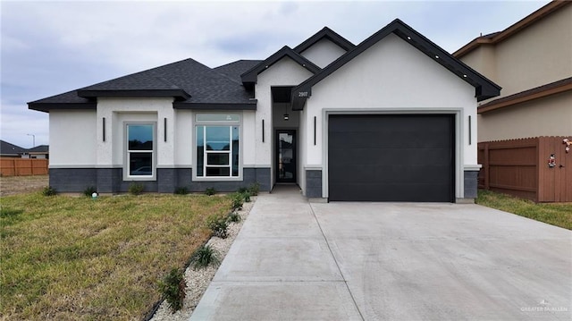 view of front of property featuring a garage and a front lawn