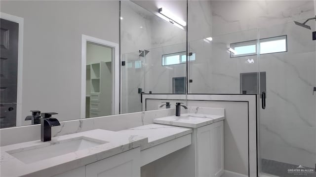 bathroom with vanity and a shower with shower door