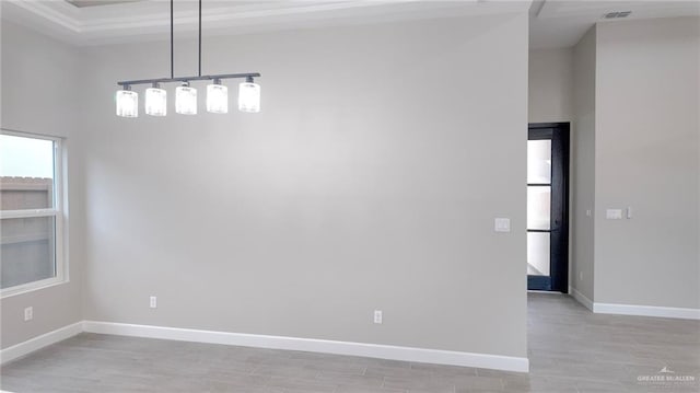 spare room with light wood-type flooring and a high ceiling