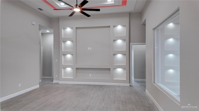 unfurnished living room featuring ceiling fan and light hardwood / wood-style flooring