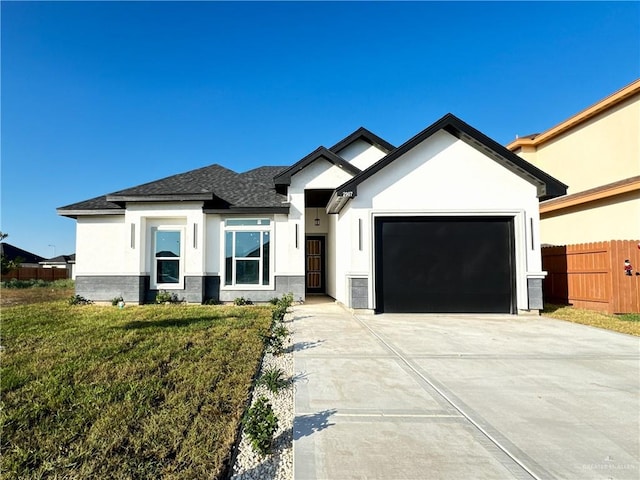 view of front facade featuring a front yard and a garage