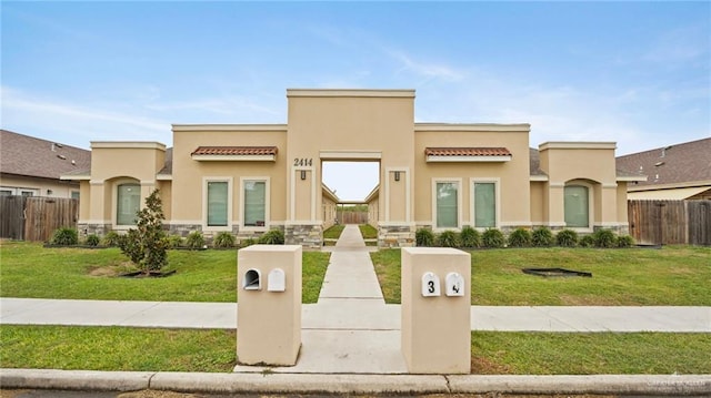 pueblo-style home with a front yard