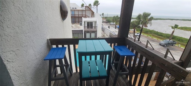 balcony featuring a water view