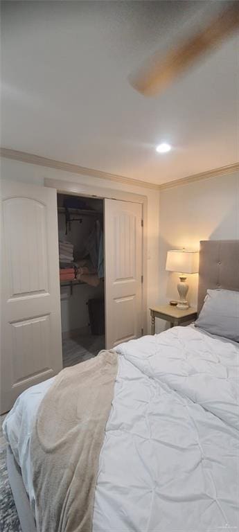 bedroom with crown molding and a closet