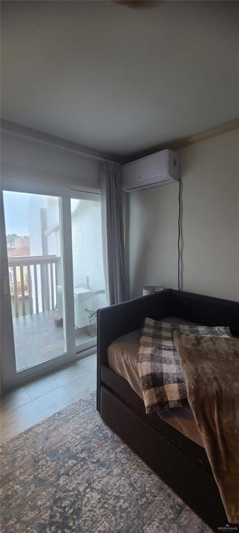 bedroom with access to exterior and an AC wall unit