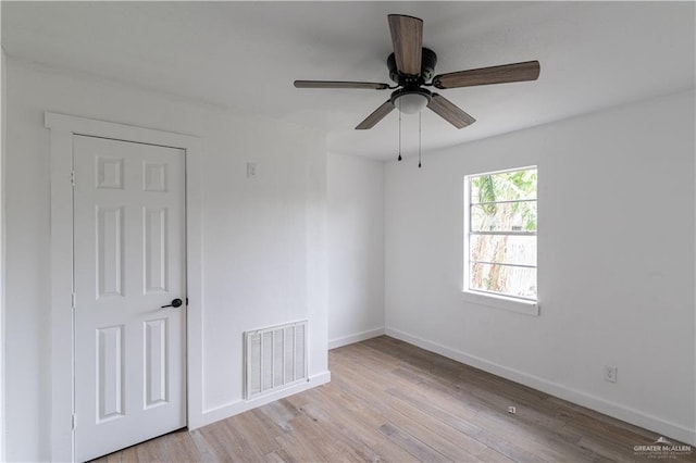 spare room featuring ceiling fan and light hardwood / wood-style floors