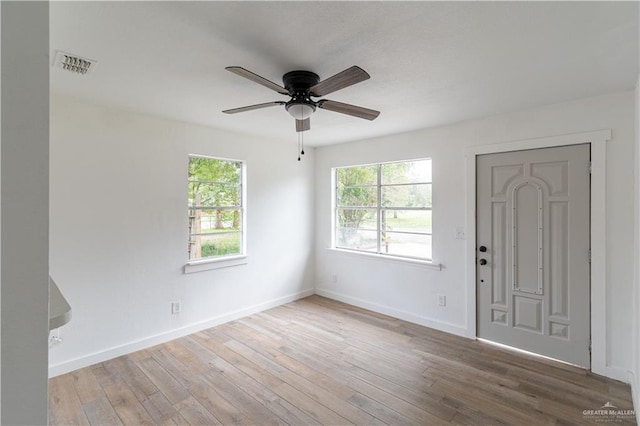 empty room with ceiling fan and hardwood / wood-style flooring