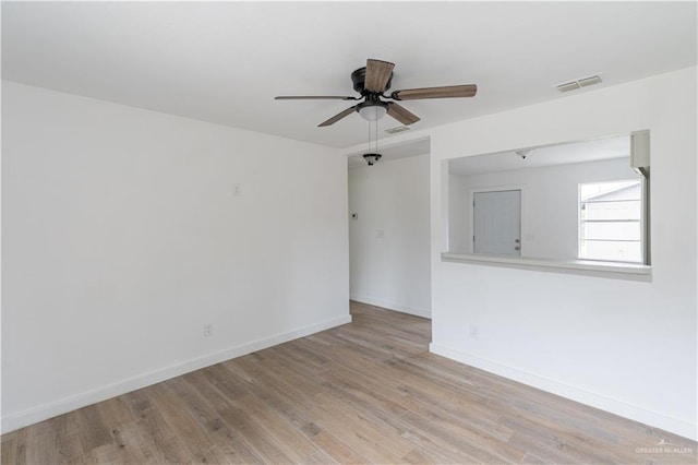 unfurnished room with light wood-type flooring and ceiling fan