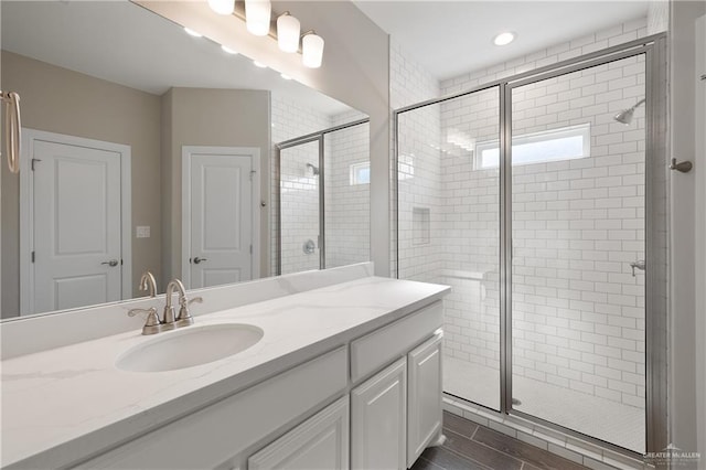 bathroom featuring vanity and an enclosed shower