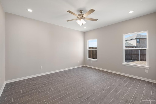 empty room featuring ceiling fan and dark hardwood / wood-style flooring