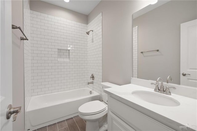 full bathroom featuring vanity, toilet, and tiled shower / bath