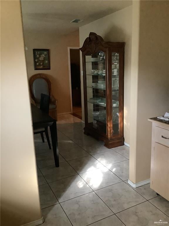 hallway featuring light tile patterned floors