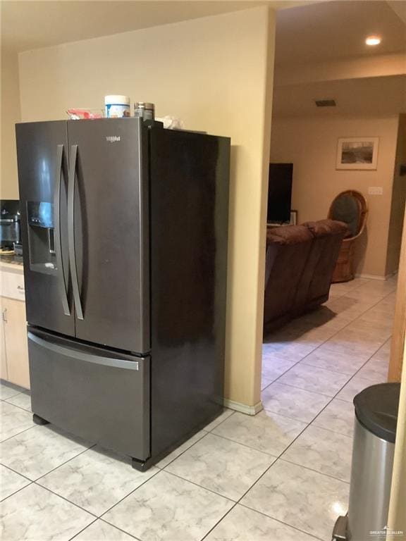 kitchen with white cabinetry, stainless steel fridge with ice dispenser, and light tile patterned floors