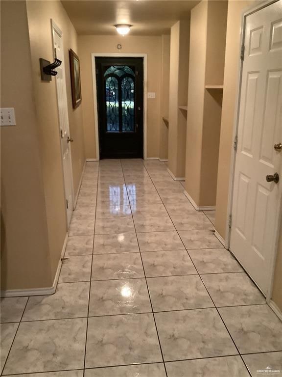 entryway with light tile patterned floors