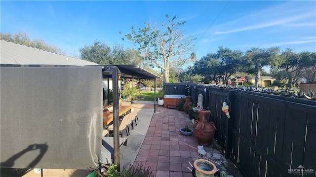 view of patio / terrace with a hot tub