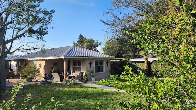 rear view of house with a lawn