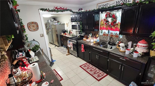 kitchen featuring sink, ornamental molding, light tile patterned floors, tasteful backsplash, and stainless steel appliances