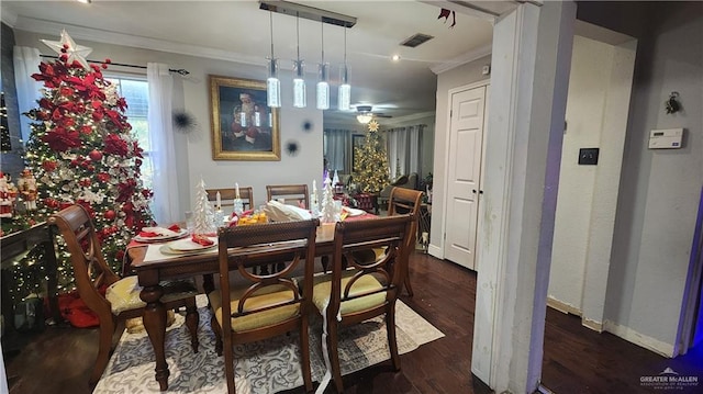 dining space featuring dark hardwood / wood-style floors and ornamental molding