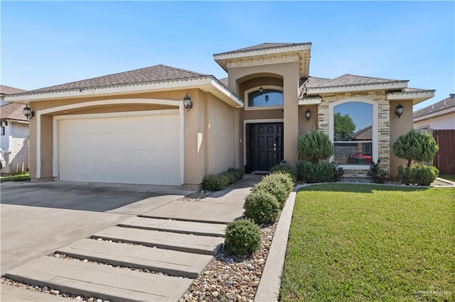 mediterranean / spanish-style house featuring a garage and a front yard