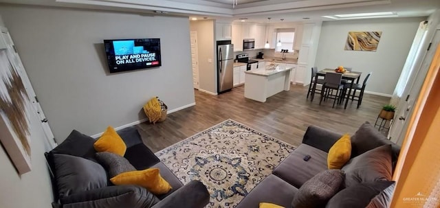 living room with sink and dark hardwood / wood-style floors