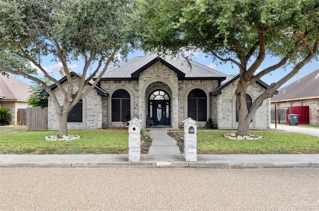 2311 Nappa Valley Dr, Mission, TX 78573 - french country home with brick siding and roof with shingles