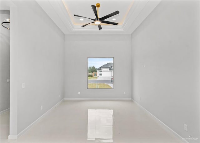 unfurnished room featuring ceiling fan, ornamental molding, and a tray ceiling