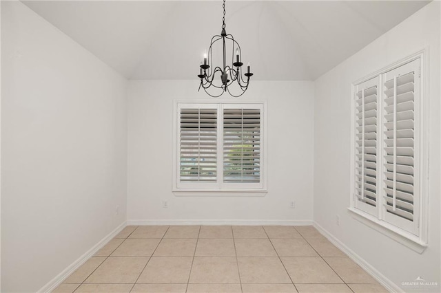 507 Edgewood Ave, Edinburg, TX 78541 - unfurnished dining area with tile patterned flooring, vaulted ceiling, a chandelier, and baseboards