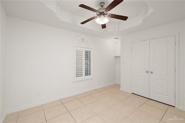 507 Edgewood Ave, Edinburg, TX 78541 - unfurnished bedroom featuring light tile patterned floors, a raised ceiling, baseboards, and a closet