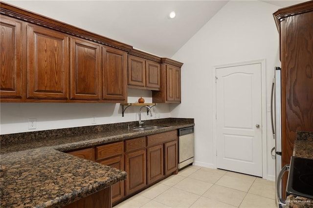 507 Edgewood Ave, Edinburg, TX 78541 - kitchen with appliances with stainless steel finishes, dark countertops, a sink, light tile patterned flooring, and lofted ceiling