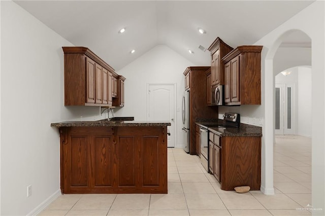 507 Edgewood Ave, Edinburg, TX 78541 - kitchen with light tile patterned flooring, arched walkways, appliances with stainless steel finishes, and vaulted ceiling