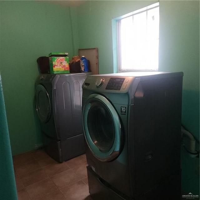 washroom featuring separate washer and dryer and light tile patterned floors