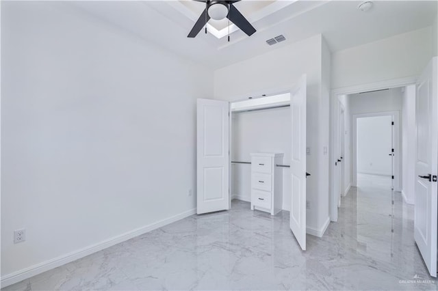 unfurnished bedroom featuring a closet, visible vents, baseboards, marble finish floor, and ceiling fan