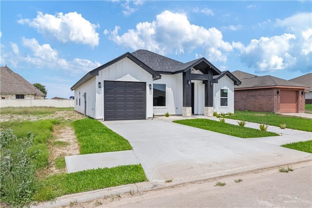 view of front facade with an attached garage, concrete driveway, and board and batten siding