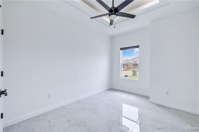 empty room featuring baseboards, marble finish floor, and a ceiling fan