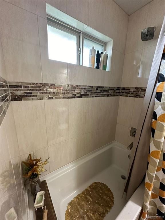 bathroom with shower / bath combo with shower curtain