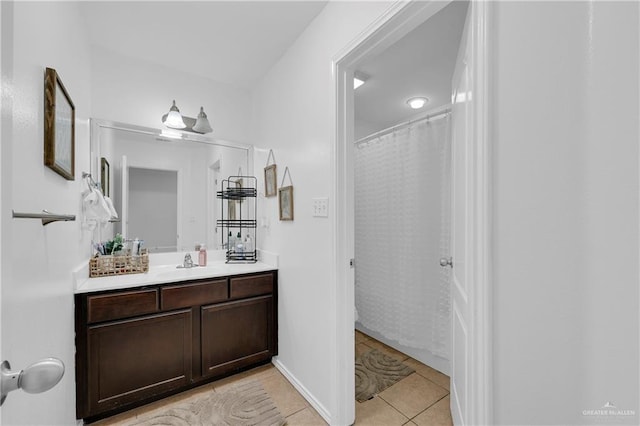 bathroom featuring tile patterned flooring, vanity, and baseboards