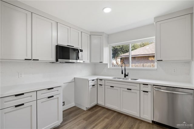 3400 Ozark Ave, Mcallen, TX 78504 - kitchen with light wood-type flooring, recessed lighting, light countertops, stainless steel appliances, and a sink